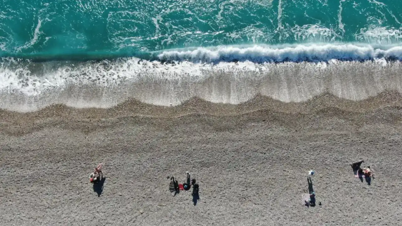 sari-kod-uyarisi-sonrasi-antalyada-gunes-acti-vatandaslar-konyaalti-sahiline-akin-etti